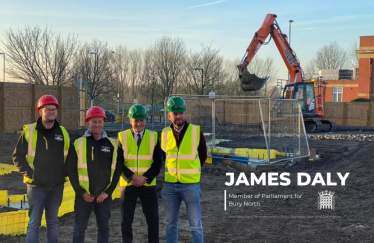 James Daly and Bury College Princpal Charlie Deane standing with the contractors who are assembling the new building at Bury College for the Institute of Technology